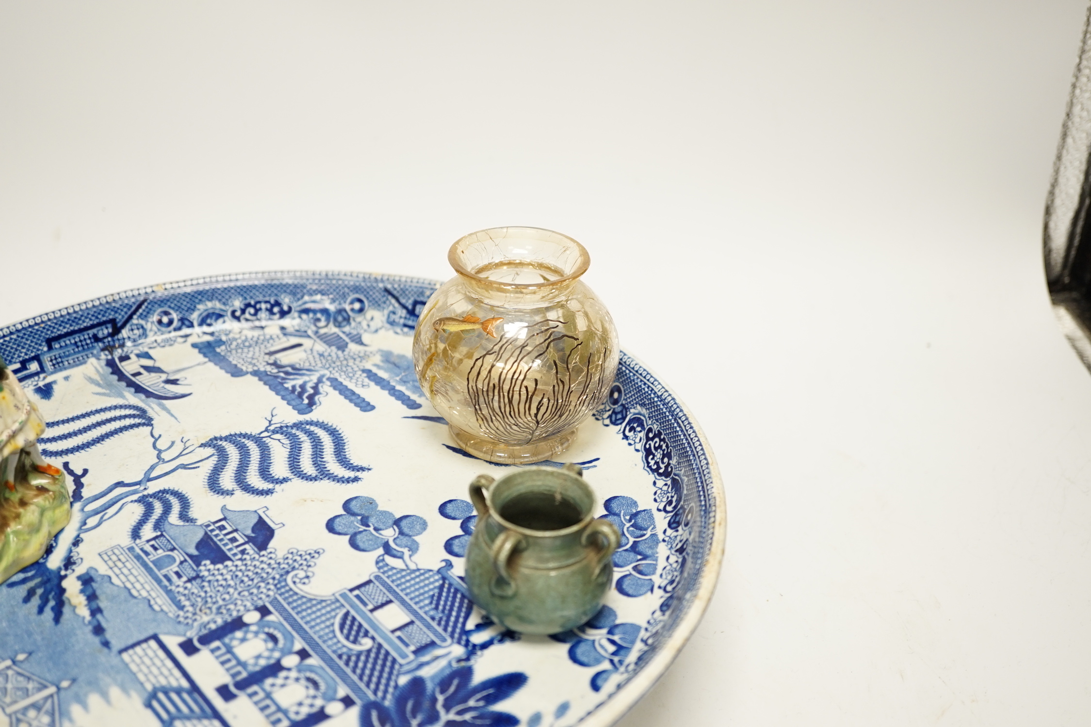 A group of mixed ceramics including a Moser crackle glass fish vase, Delft seated lady figurine, willow pattern comport, figural soap dish, maiolica match strike etc.